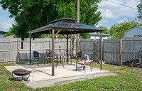 Backyard covered grill fire pit area